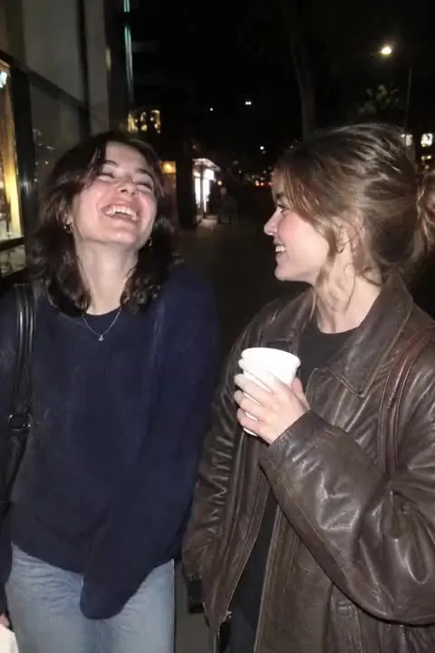 A photo of two friends laughing, before Tada